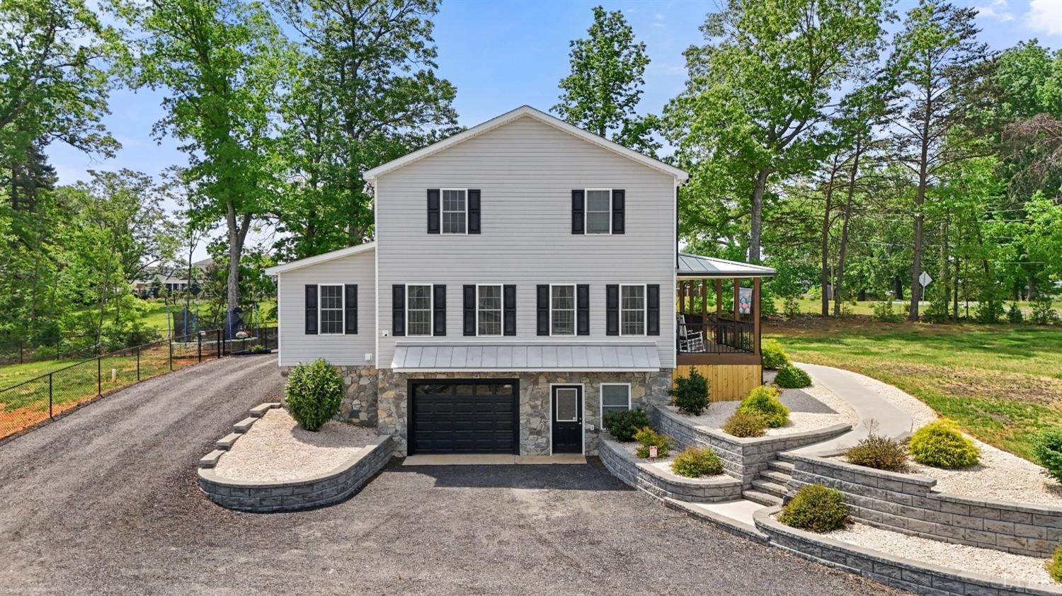 4607 Lowry Road Goode, VA 24556 - Photo 51 of 64 a front view of a house with a yard patio and fire pit