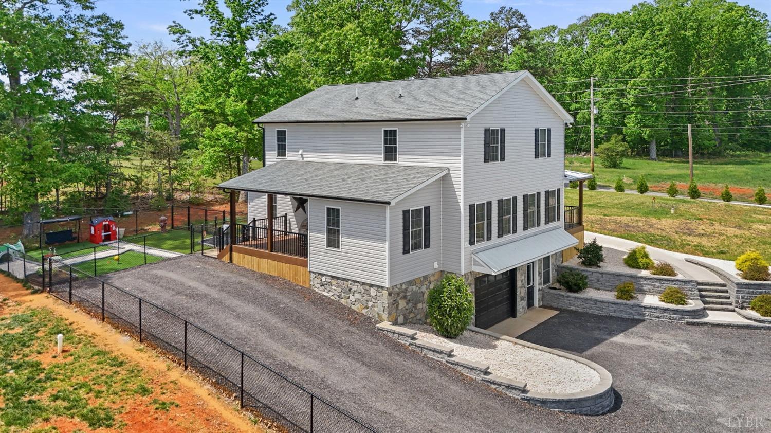4607 Lowry Road Goode, VA 24556 - Photo 52 of 64 a view of a house with a yard and sitting area