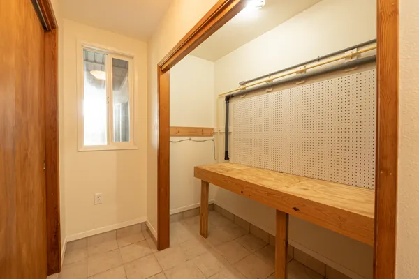 a view of walk in closet with empty racks