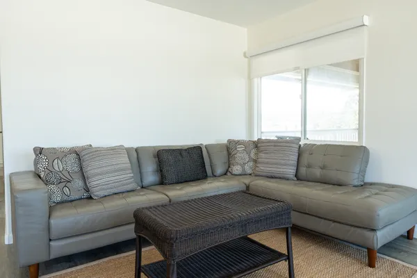 a living room with a couch and a window