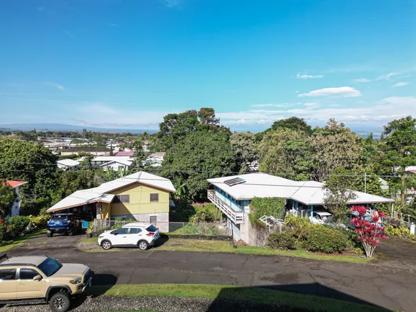 a view of outdoor space with cars parked