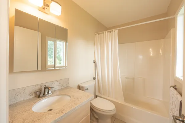 a bathroom with a sink toilet and shower