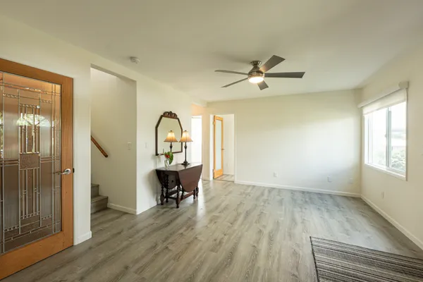 a view of a workspace with wooden floor and a ceiling fan