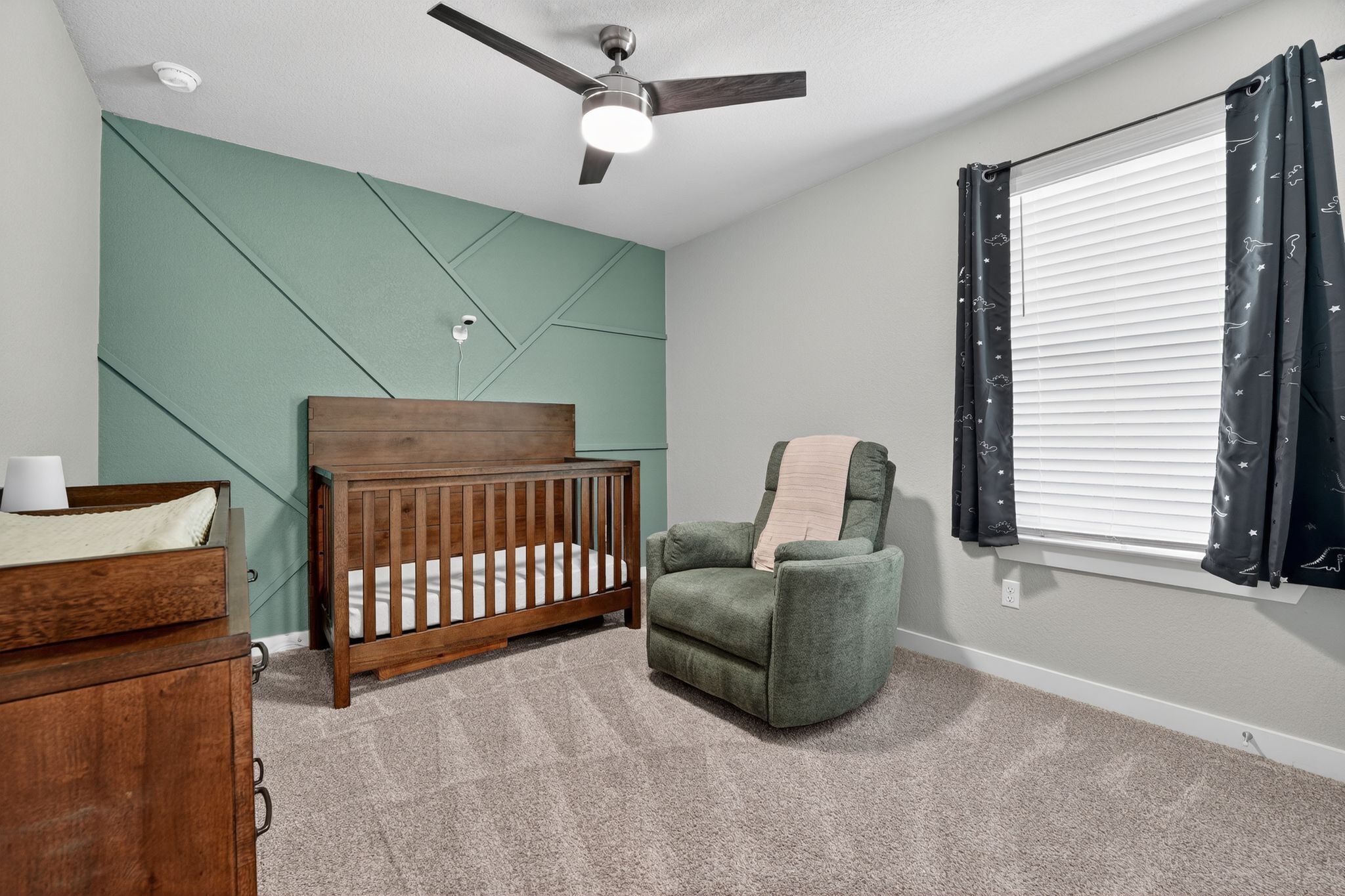 117 Halford Road Georgetown, TX 78633 - Photo 23 of 31 Bedroom featuring a nursery area, ceiling fan, and light colored carpet