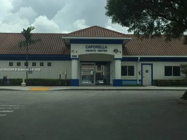 a front view of a building with a garden
