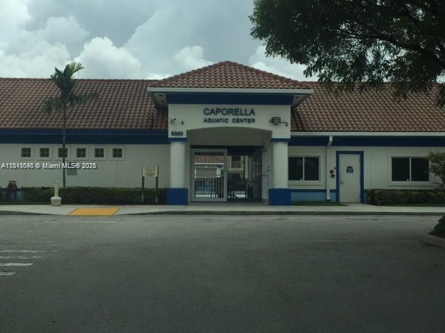 9247 Chambers Street Tamarac, FL 33321 - Photo 12 of 21 a front view of a building with a garden