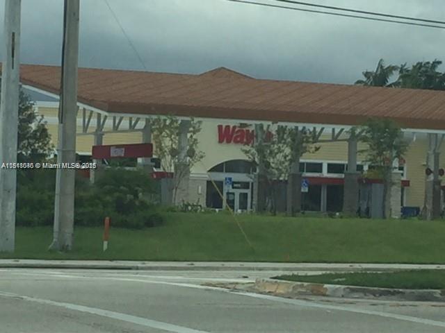 9247 Chambers Street Tamarac, FL 33321 - Photo 13 of 21 a front view of a house with a yard