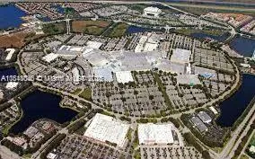 a view of a house with a yard and potted plants