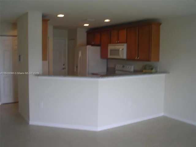 a view of kitchen with cabinets and wooden floor
