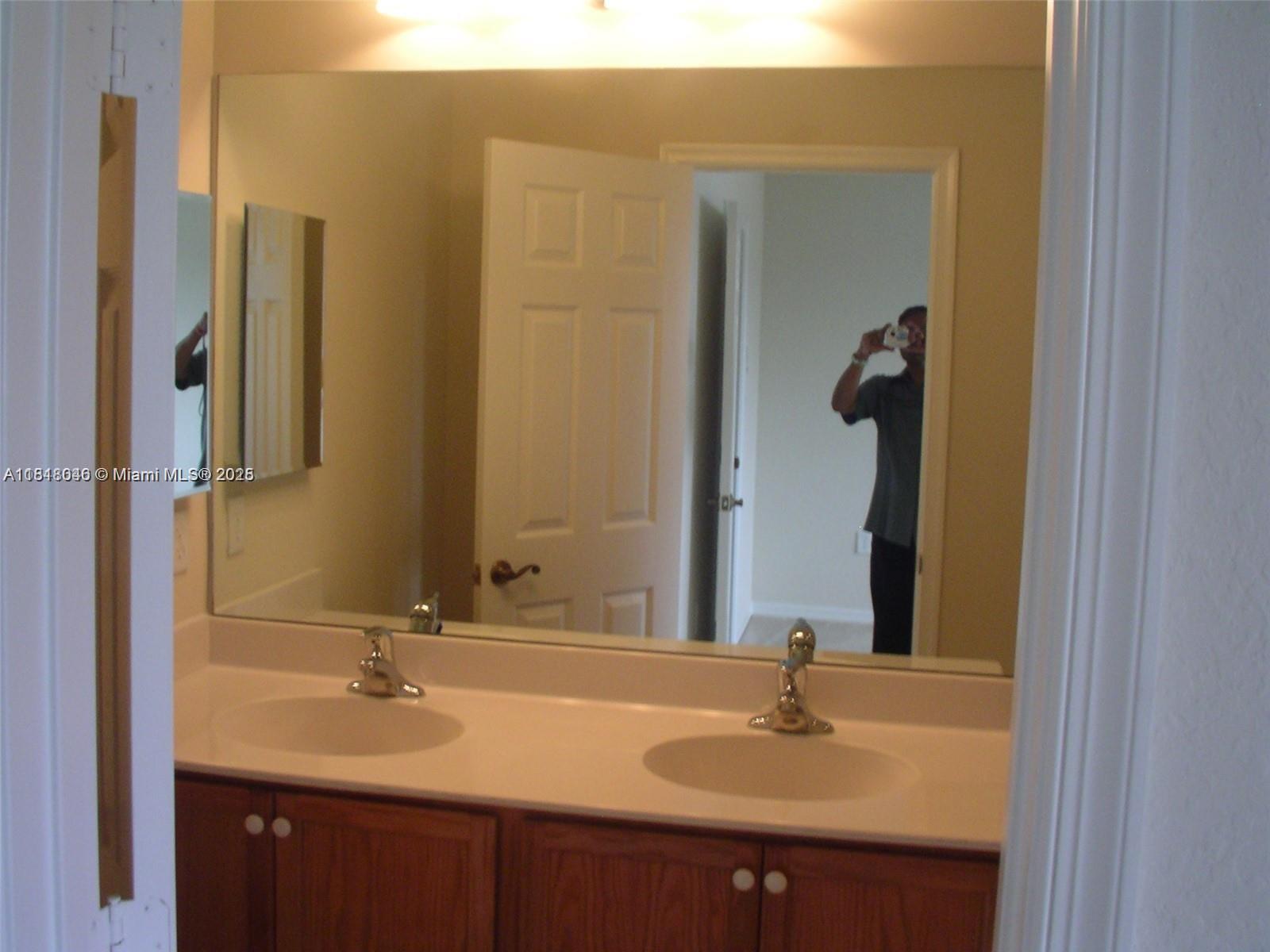 9247 Chambers Street Tamarac, FL 33321 - Photo 7 of 21 a bathroom with a sink and a mirror