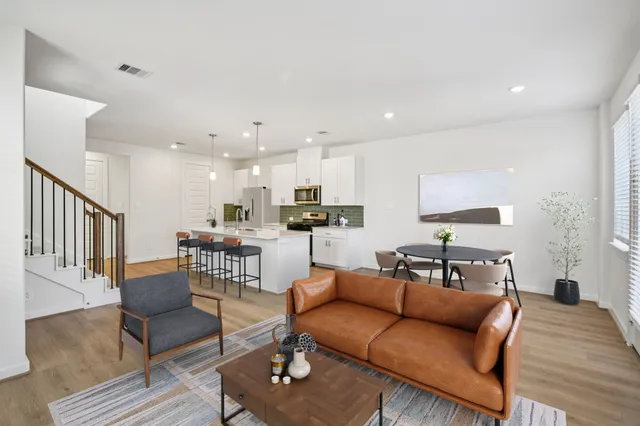 a living room with furniture kitchen view and a dining table