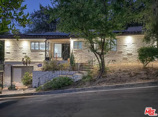 a white toilet sitting next to a bathroom sink and a shower