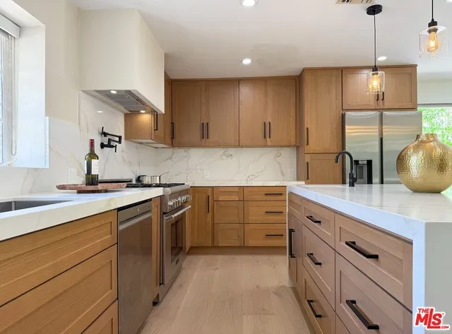 a kitchen with cabinets and window