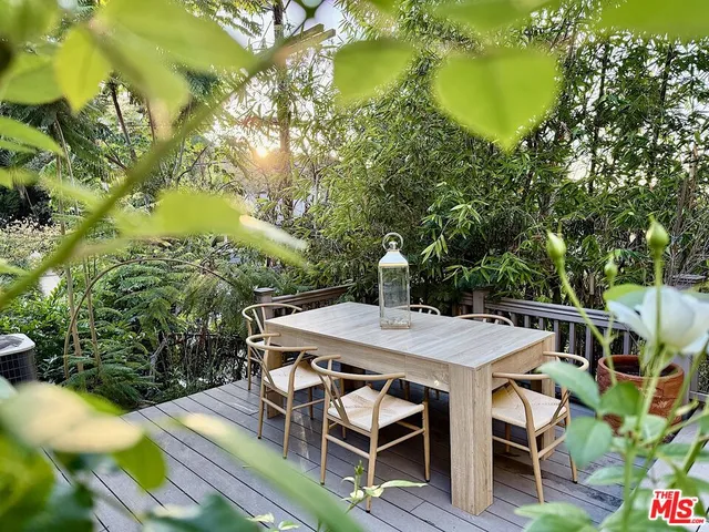 a view of a patio with table and chairs and potted plants