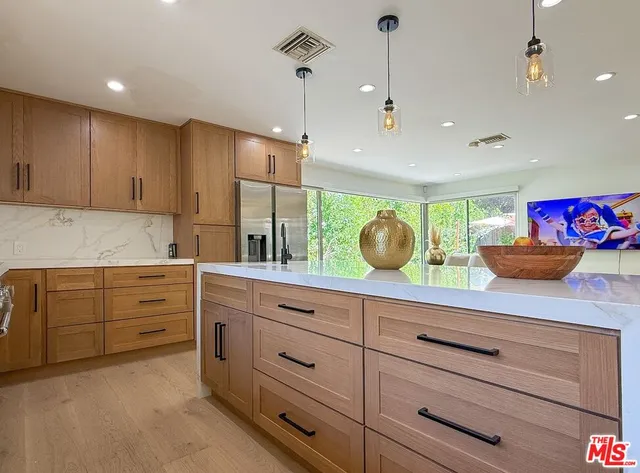a kitchen with cabinets appliances and cabinets