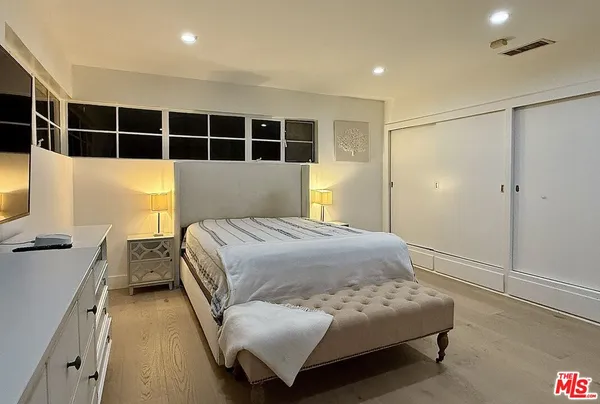 a bedroom with furniture and a window