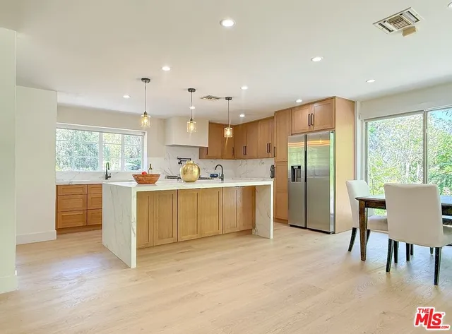 a large kitchen with a table and chairs