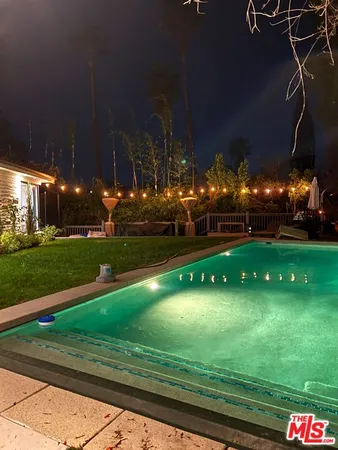 a living room with furniture a ceiling fan and a rug