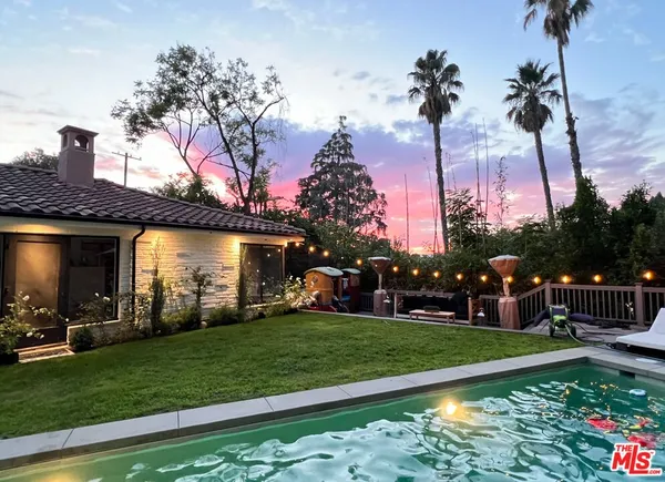a view of a house with a yard porch and sitting area