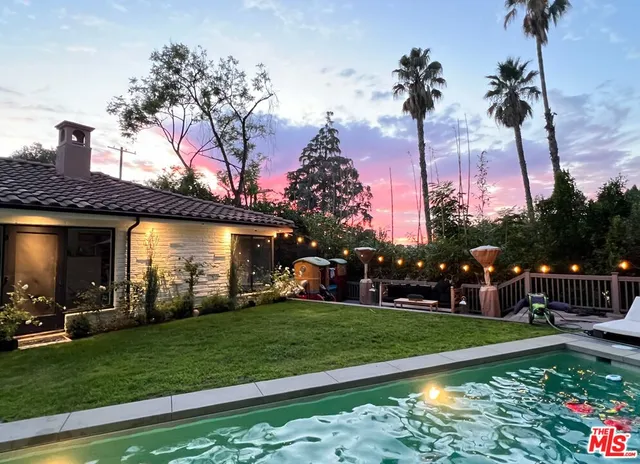 a view of a house with a yard porch and sitting area