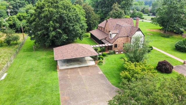 a front view of a house with yard and green space
