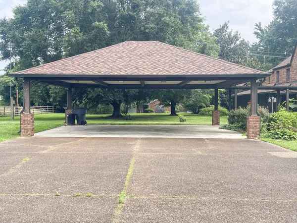 front view of a house next to a yard