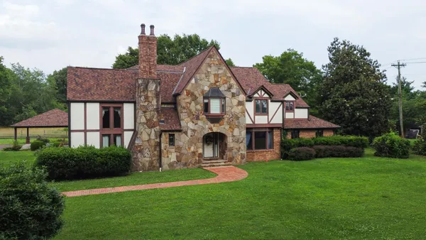 a front view of house with yard and green space
