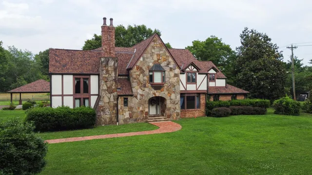 a front view of house with yard and green space