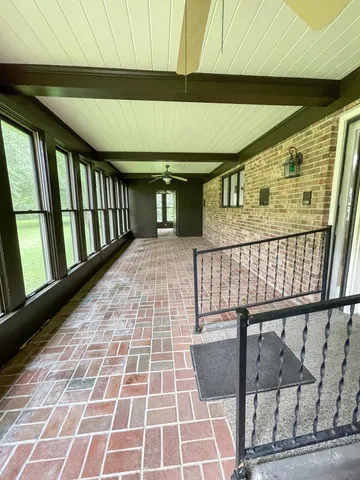 a large kitchen with stainless steel appliances granite countertop a stove a refrigerator a sink dishwasher and wooden cabinets with wooden floor