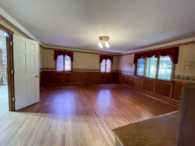 a view of a livingroom with a fireplace and a window