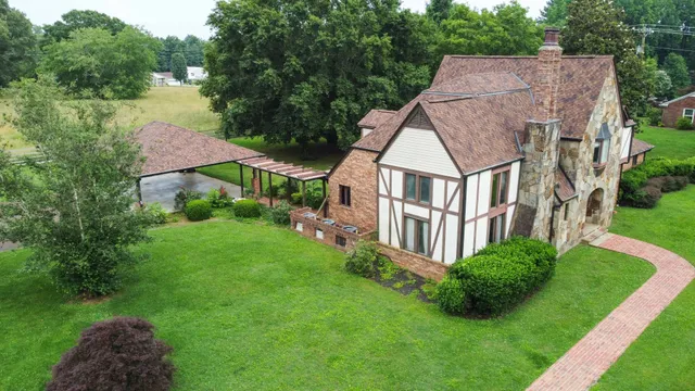 a view of a house with garden and yard