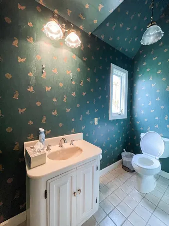 a view of staircase with lots of frames on wall and a window