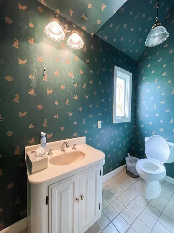 a kitchen with a stove and wooden floor