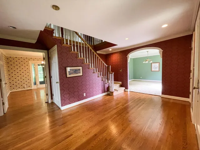 a spacious bathroom with a double vanity sink a mirror and a bathtub