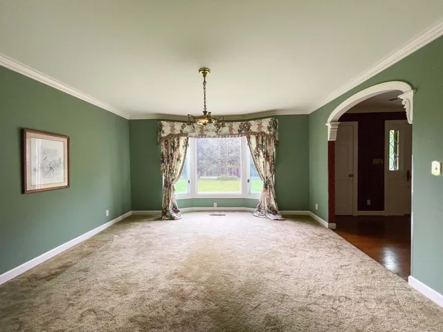 a view of staircase with lots of frames on wall and a window