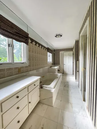 a bathroom with a double vanity sink and a mirror