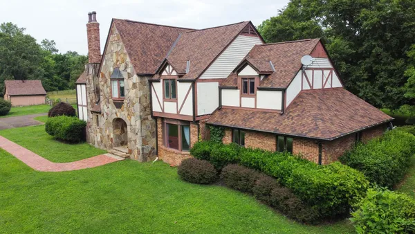 a front view of a house with a yard