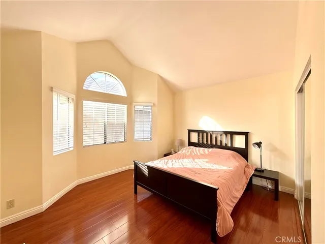 a bedroom with a bed and wooden floor