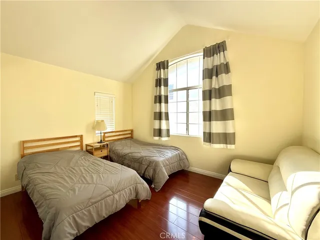 a bedroom with two beds and a couch