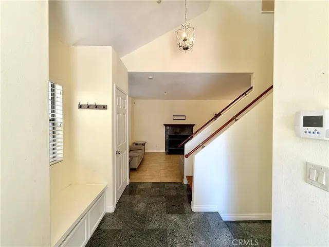 a view of a hallway with bathroom and a shower