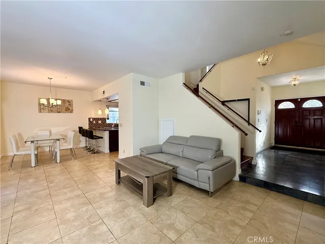 a living room with furniture and a potted plant