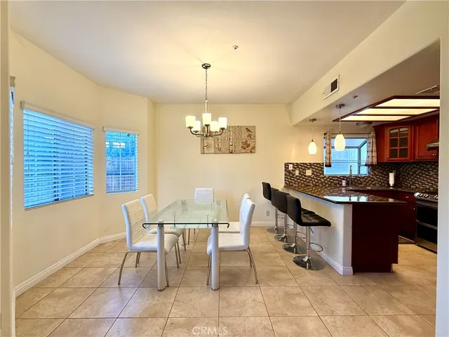 a view of a dining room with furniture and chandelier