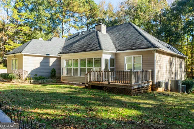 a view of a house with a yard and sitting area