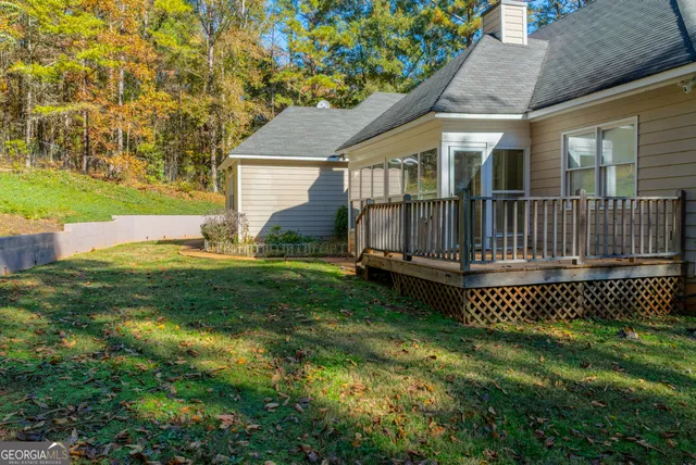 a view of backyard with a garden and deck