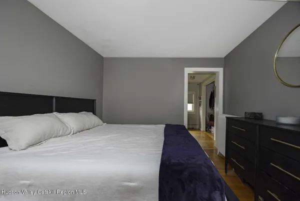a bedroom with a bed and a dresser
