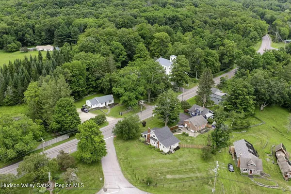 an aerial view of a house with a yard