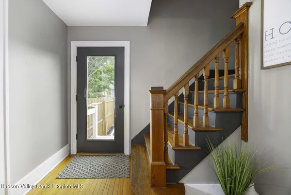 a view of an entryway with wooden floor and door