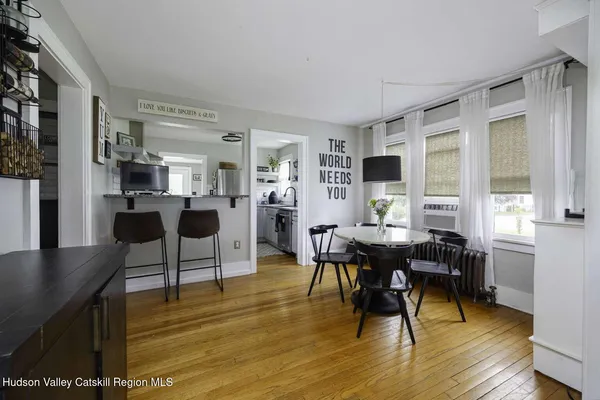 a view of a dining room with furniture and wooden floor