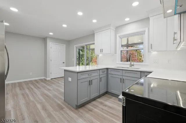 a kitchen with a sink cabinets and wooden floor