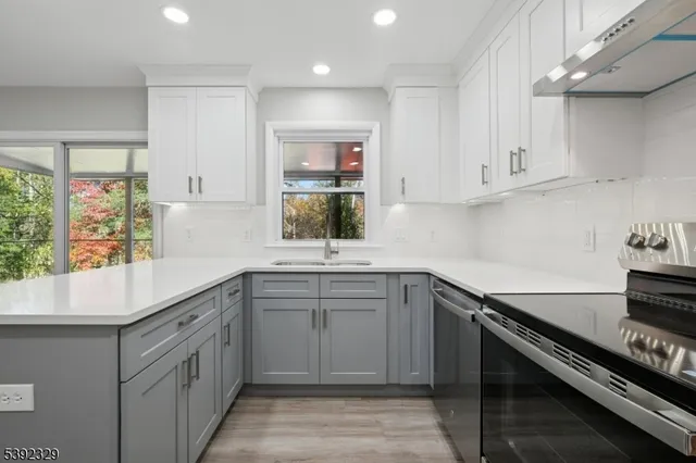 a kitchen with cabinets appliances and a window